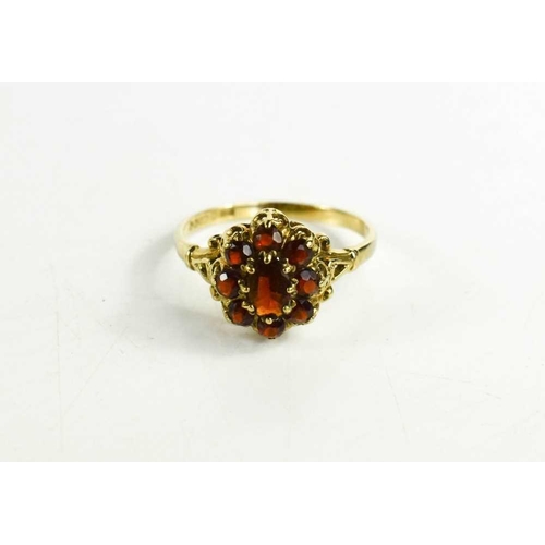 69 - A 9ct gold and flame red stone cluster ring, possibly garnets, size Q/R, 2.4g.