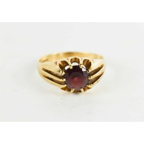 73 - A 9ct gold and garnet dress ring, the shoulders of triple banded form, size Q, 3.40g.