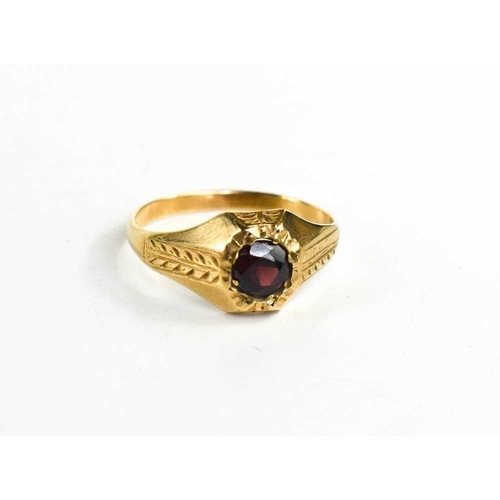 75 - A 9ct gold and garnet ring, the solitaire stone inset, with floral band to the shoulders, size T, 2.... 