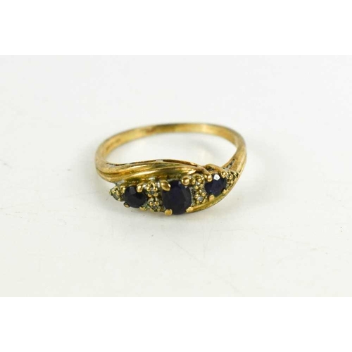 80 - A 9ct gold diamond and sapphire ring, set with three graduated oval cut sapphires, size R, 2.4g.