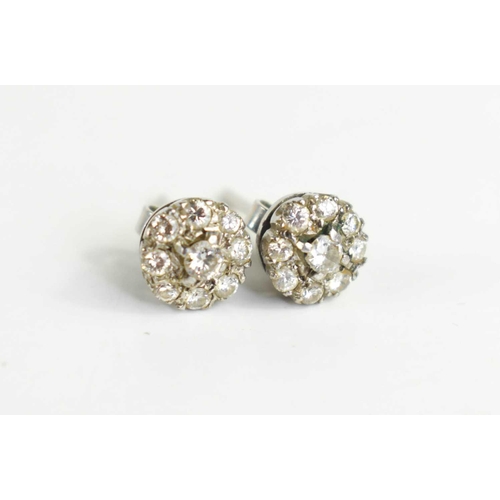 90 - A pair of diamond flowerhead earrings, each set with a central diamond surrounded by eight further s... 