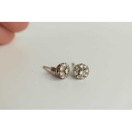 90 - A pair of diamond flowerhead earrings, each set with a central diamond surrounded by eight further s... 