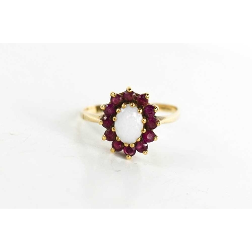 93 - A 9ct gold, opal and garnet cluster ring, the oval opal of approximately 6.75 by 4.9mm, size Q, 2.23... 