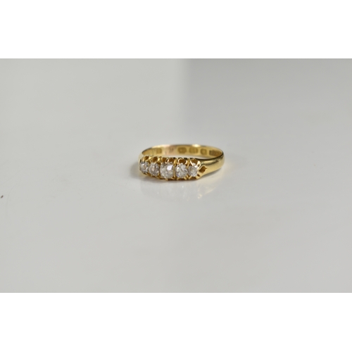 208 - An 18ct gold, and diamond five stone ring, the central diamond of approximately 4mm diameter, total ... 