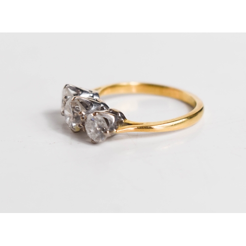 215A - A gold and diamond three stone ring, the central brilliant cut diamond approximately ½ct, flanked by... 