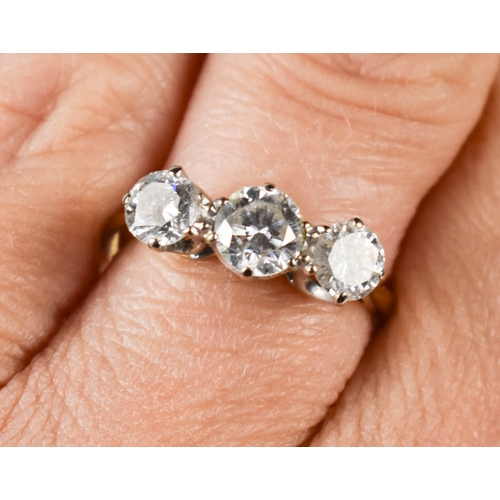 215A - A gold and diamond three stone ring, the central brilliant cut diamond approximately ½ct, flanked by... 