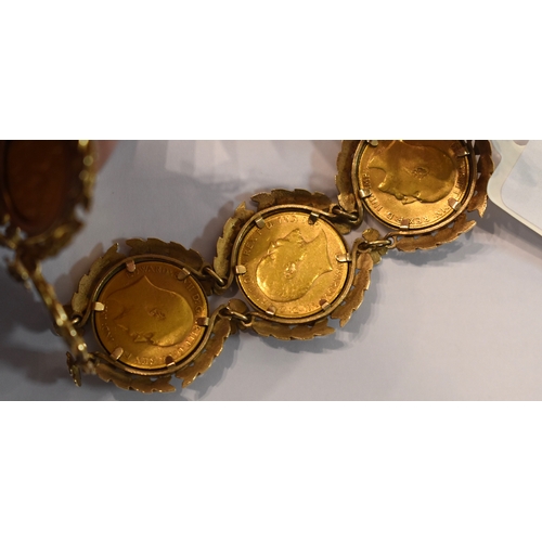 219 - A 9ct gold bracelet set with six half sovereigns, in a pretty laurel leaf and flowerhead setting to ... 