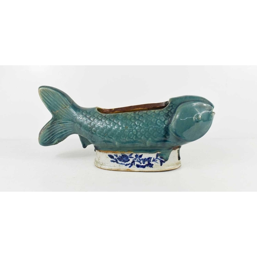 1 - A Chinese export stoneware glazed fish form planter, raised on a blue and white glazed pedestal, 37c... 