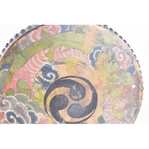 100 - A Chinese hand painted late 19th century Qing period drum, with an ebonised wooden handle, 51cm long... 