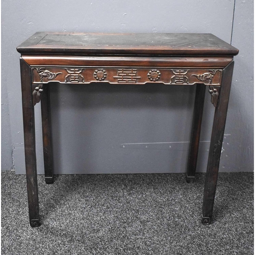 112 - A 19th century Chinese altar table, the shaped apron carved with various symbols, 86 by 90cm.