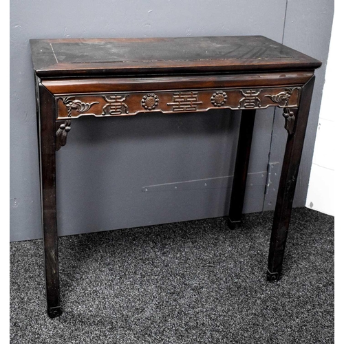 112 - A 19th century Chinese altar table, the shaped apron carved with various symbols, 86 by 90cm.