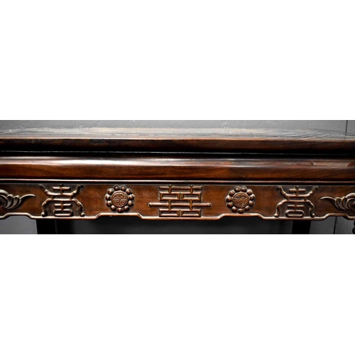 112 - A 19th century Chinese altar table, the shaped apron carved with various symbols, 86 by 90cm.