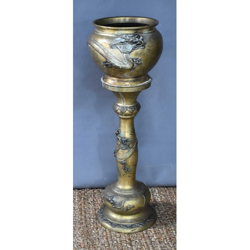 115 - A Japanese Meiji period brass jardiniere on stand modelled with dragons, 88.5cm high.