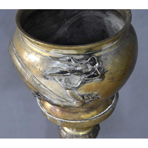 115 - A Japanese Meiji period brass jardiniere on stand modelled with dragons, 88.5cm high.