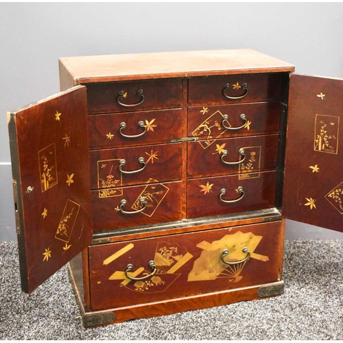 117 - A 19th century Japanese red lacquered table cabinet, the upper section having two cupboard doors, de... 