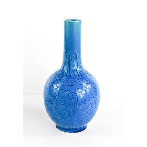 12 - A Chinese Qing Dynasty stoneware bottle vase in turquoise - blue glaze, incised underglaze floral de... 