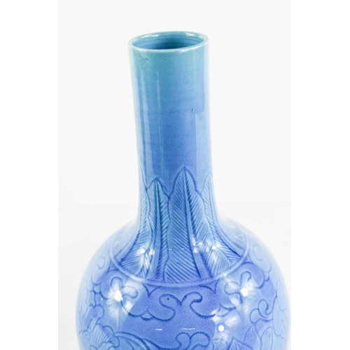 12 - A Chinese Qing Dynasty stoneware bottle vase in turquoise - blue glaze, incised underglaze floral de... 