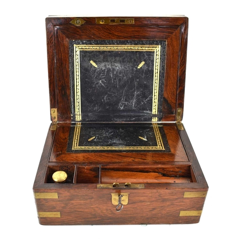 125 - A Victorian rosewood writing box with brass mounts, the fitted interior having a green leather skive... 