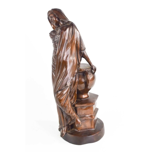 146 - A 20th century bronzed metal figure of a lady reclining against an urn, 30cm high.