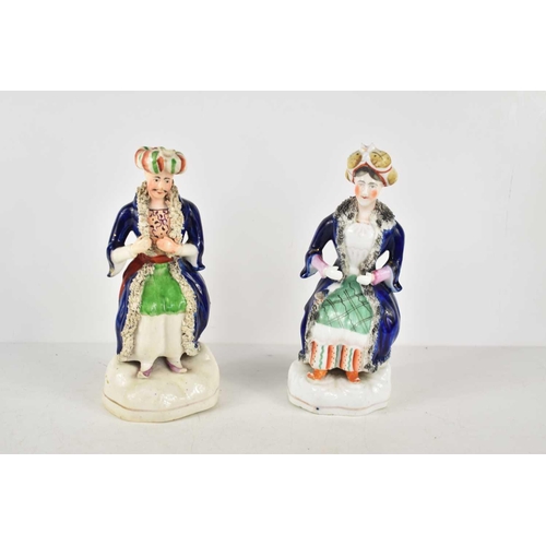 151 - A pair of 19th century Staffordshire figures of seated Turkish men, 20cm high.