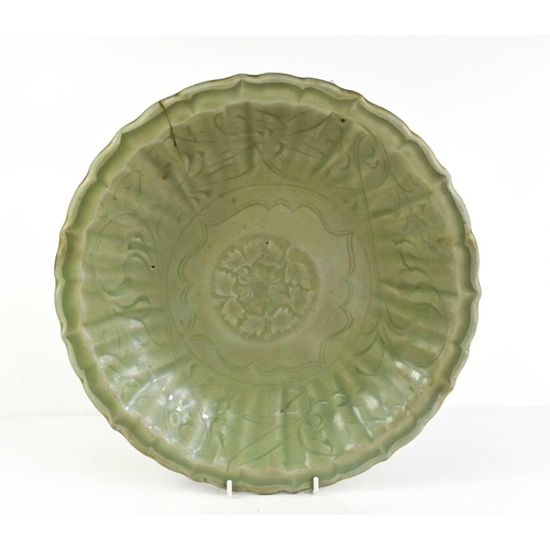 17 - A 'Longquan' celadon shallow footed bowl, with floral centre, sturdily-potted, the shallow rounded s... 