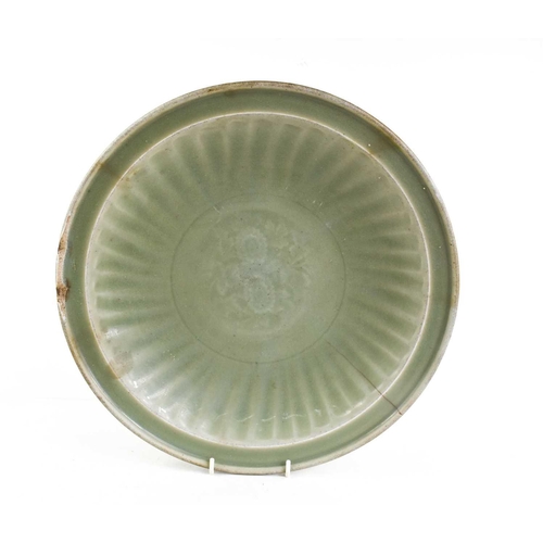 18 - A 'Longquan' celadon shallow footed bowl with floral central roundel, sturdily-potted, the shallow f... 