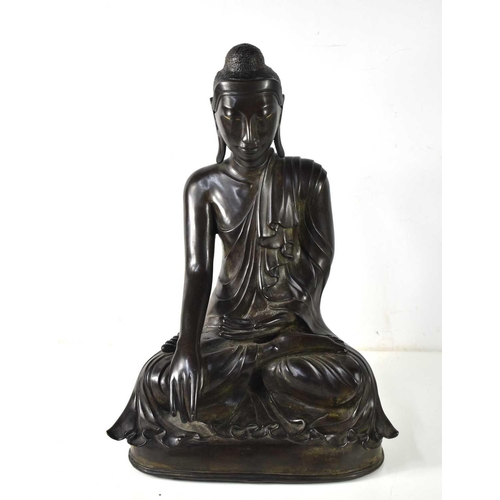 20 - A large Mandalay period bronze figure of a seated buddha, the left hand resting on his lap, palm up ... 