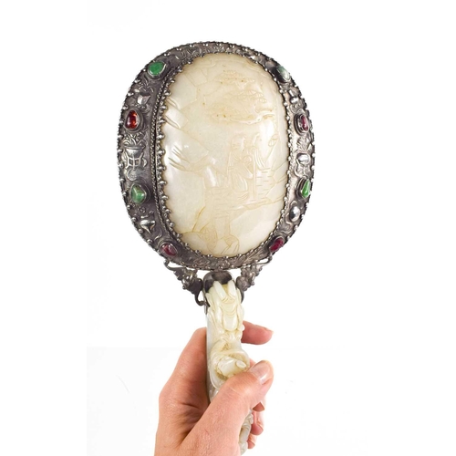 26 - A Qing Dynasty (1644-1912) Chinese white metal and jade hand mirror, comprising a large openwork bel... 