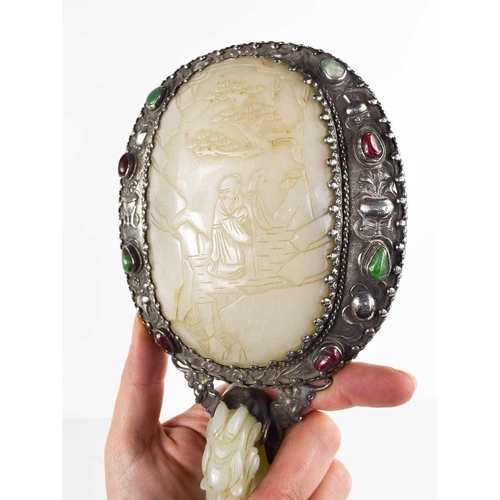 26 - A Qing Dynasty (1644-1912) Chinese white metal and jade hand mirror, comprising a large openwork bel... 