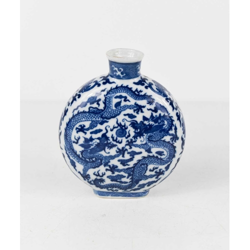 3 - A Chinese blue and white porcelain moon flask of small proportions, decorated with five claw writhen... 