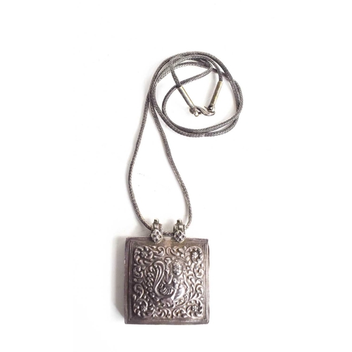 33 - An Indian white metal pendant necklace, the pendant embossed with a Kinnara; a mythical half bird-ha... 