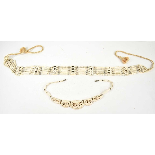 34 - A large carved bone five strand necklace, 73cm, together with a smaller bone necklace with carved fl... 