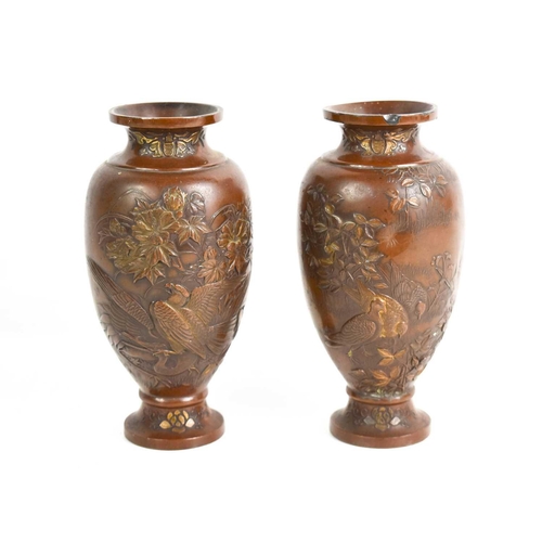 39 - A pair of 19th century Chinese bronze vases, cast with various birds amidst flowers, 16cm high.