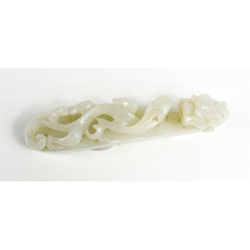 4 - A Chinese 19th century jade button / belt hook, the top in the form of a dragon head, 11.5cm long.