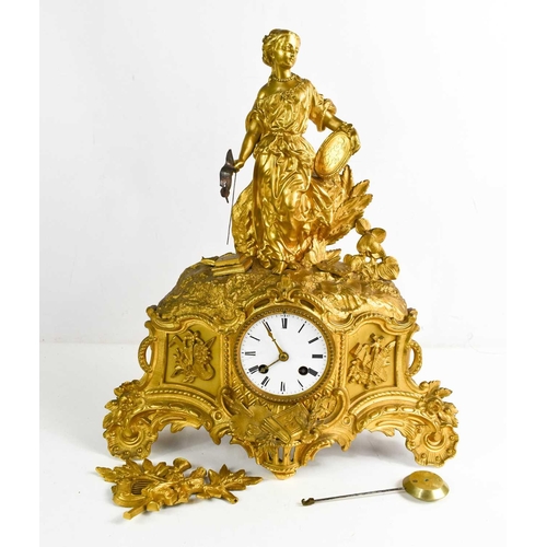 412 - A 19th century French gilt metal mantle clock, depicting a female figure representing the arts, with... 