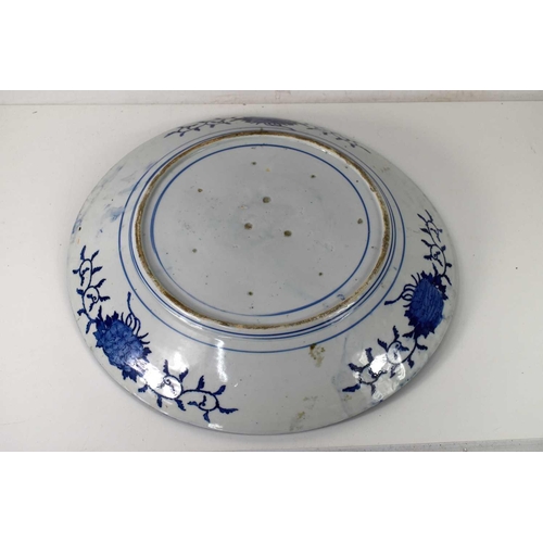 46 - An early 19th century Chinese blue and white porcelain charger, decorated with a peacock amongst fol... 