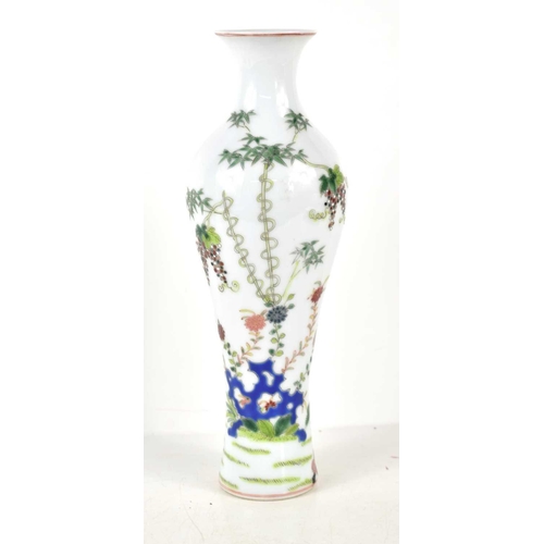 47 - A 20th century Chinese vase of baluster form, decorated with flowers, fruits and insects, 27cm.