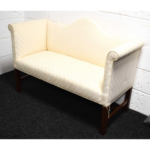 532 - A small mahogany camel back window seat / bed end, upholstered in cream, raised on mahogany legs and... 