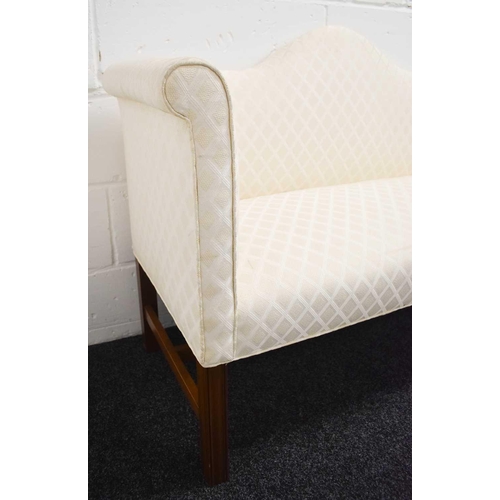 532 - A small mahogany camel back window seat / bed end, upholstered in cream, raised on mahogany legs and... 