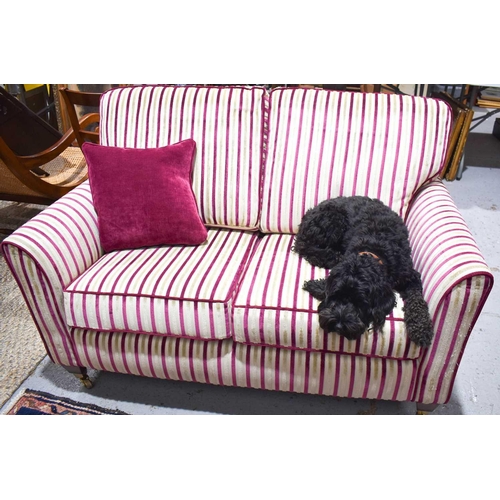 534 - A modern Anvils of Stamford two seater settee, in striped cream and burgundy, with mahogany feet and... 