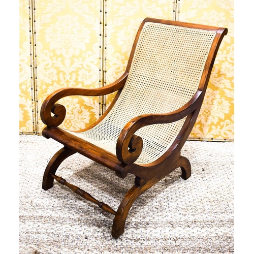 536 - A Regency period mahogany bergere armchair circa 1810, with caned back and scrollwork arms, with ori... 