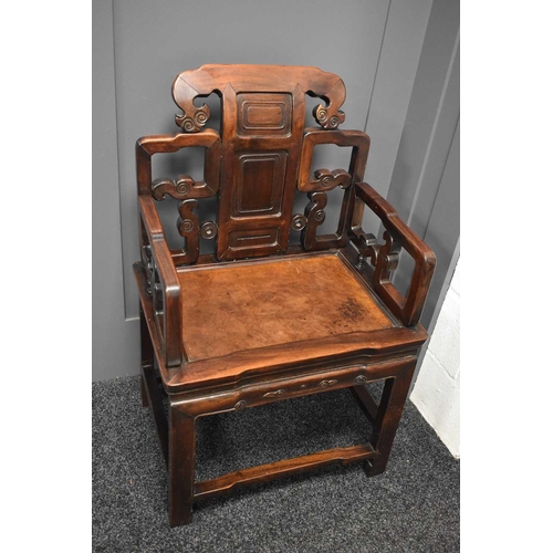 537 - A 19th century Qing dynasty throne chair, the open carved back with three fielded panels, scroll car... 