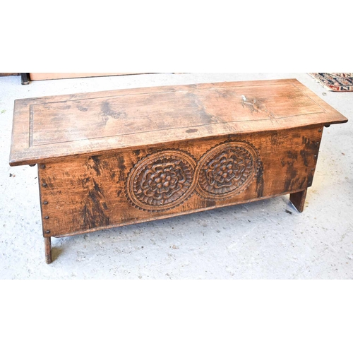 540 - An Arts & Crafts oak carved coffer, the canted arch cut end boards joined to the front panel carved ... 