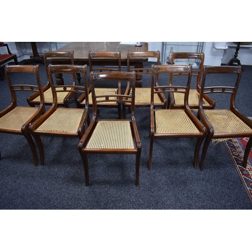 541 - A set of nine 19th century dining chairs with woven cane seats, turned back supports and sabre legs.