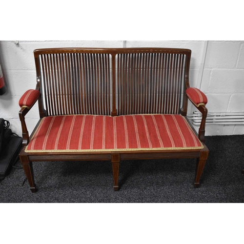 542 - An Edwardian mahogany framed settee with rectangular slatted back, satinwood inlaid decoration, upho... 