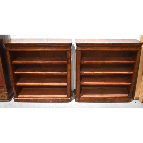 543 - A pair of Victorian flame mahogany four tier open bookcases, raised on plinth bases, 102cm by 105cm ... 