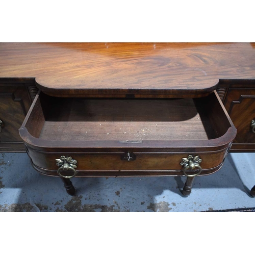 545 - A Regency mahogany breakfront sideboard, the central drawer flanked by a cupboard and cellarette dra... 