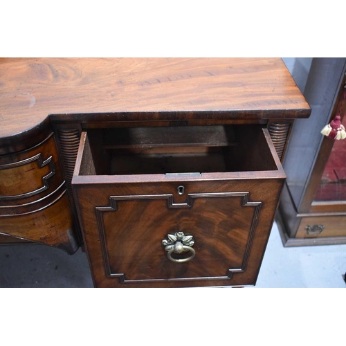 545 - A Regency mahogany breakfront sideboard, the central drawer flanked by a cupboard and cellarette dra... 