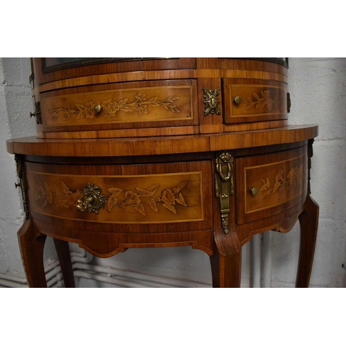 547 - A 19th century Louis XIV style French kingwood demi-lune vitrine, the single bow front door opens to... 