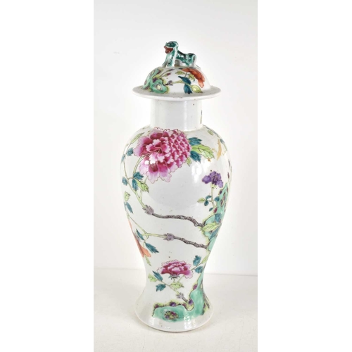 59 - A Chinese Famille Rose vase, Qing Dynasty, decorated with flowers and trees, the lid having a Foo do... 